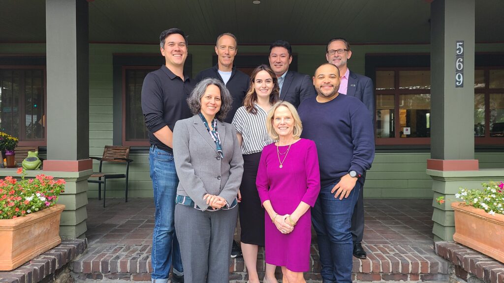 IEA Board of Directors standing on the steps in front of IEA's office